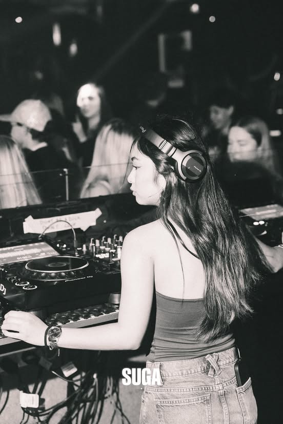 A DJ at the SUGA booth in black and white
