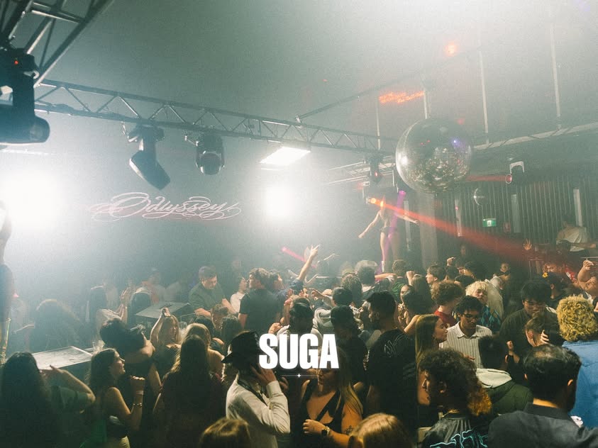 The SUGA dancefloor beneath coloured lights and a mirror ball