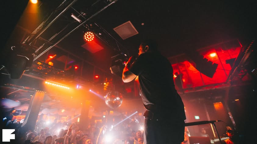 Xzibit performing under red lights at Fiction